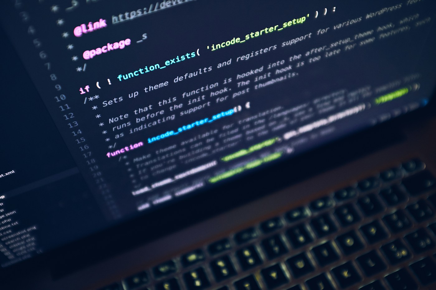 Laptop screen showing application code in a dark editor